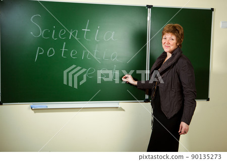 professor against blackboard background 90135273