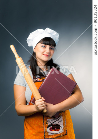 woman cook with book and rolling pin 90135324