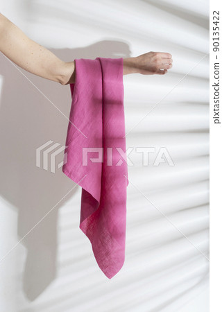 pink linen fabric on the woman hand 90135422