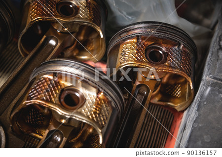 Old used engine pistons close up. Four pistons from an old disassembled engine 90136157