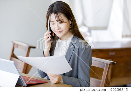一邊看資料一邊詢問的女性 一邊看資料一邊詢問的女性 90136845