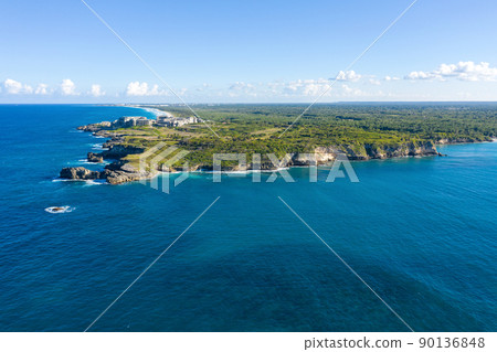 Macao beach with sandy coastline, turquoise water and stone cliff. Famous shore for surfing in Dominican Republic. Aerial panorama view Macao beach with sandy coastline, turquoise water and stone cliff. Famous shore for surfing in Dominican Republic. Aerial panorama view 90136848