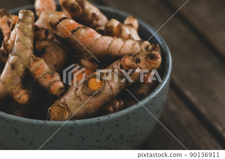 Turmeric roots in bowl Turmeric roots in bowl 90136911