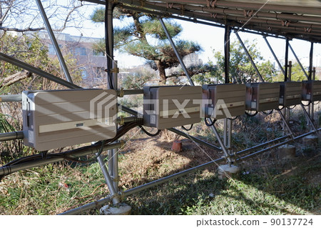 Behind the solar panel 90137724