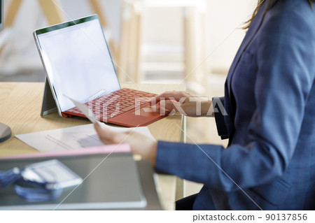 Hands of a woman working on a computer Hands of a woman working on a computer 90137856
