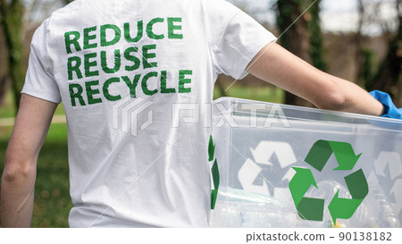 Man at plastic garbage collecting in a polluted park 90138182