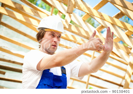 builder looking at the construction project builder looking at the construction project 90138401