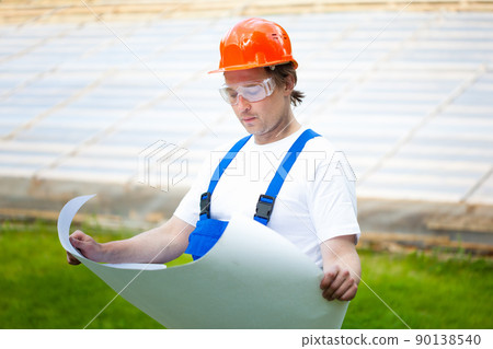 engeneer looking at the construction plan engeneer looking at the construction plan 90138540