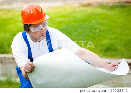 engineer looking at the blueprint 90138541