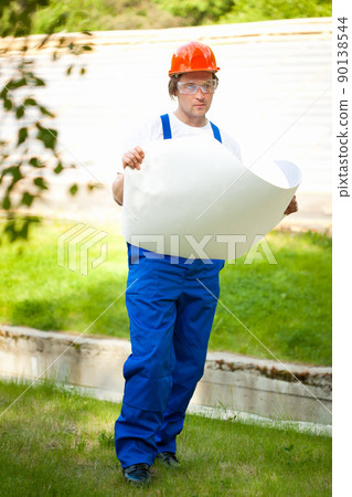 engeneer looking at the blueprint engeneer looking at the blueprint 90138544
