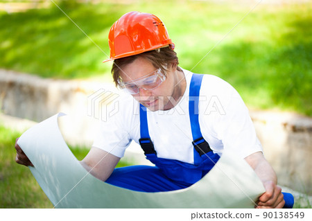 builder looking at the construction plan builder looking at the construction plan 90138549