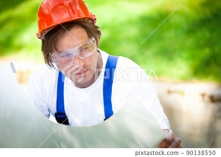 builder looking at the construction project builder looking at the construction project 90138550