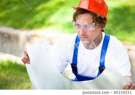 engeneer looking at the construction project engeneer looking at the construction project 90138551