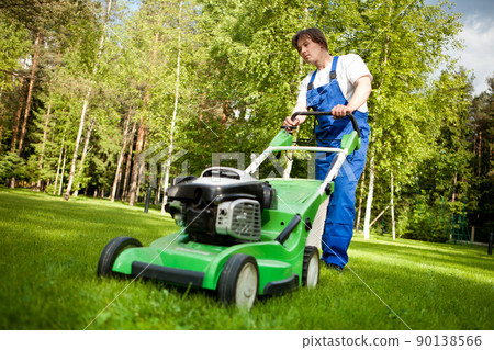lawn mover man working on the backyard 90138566