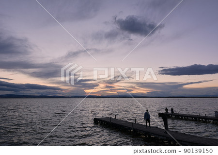 Jetty on a lake a stormy day, sunset Jetty on a lake a stormy day, sunset 90139150