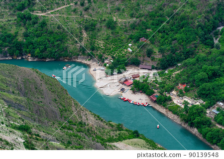 top view of the mountain river Sulak in Dagestan with a tourist boat base top view of the mountain river Sulak in Dagestan with a tourist boat base 90139548