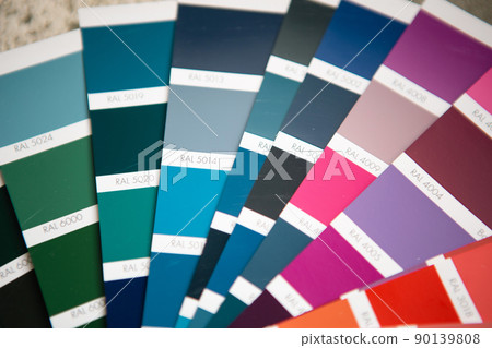 Selection of the paint color for decorative home repairs to the palette with layouts. A fan of shades in your hand inside the home. Repair and construction, paint and varnish coating 90139808