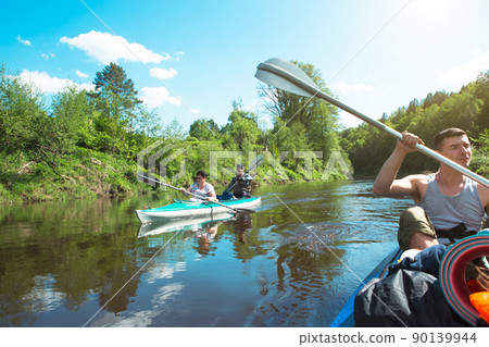 Family kayak trip. Father and daughter, and elderly couple senior and seniora rowing boat on the river, a water hike, a summer adventure. Eco-friendly and extreme tourism, active and healthy lifestyle 90139944