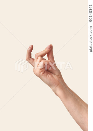 Finger snap woman hand with wrist on cream background Finger snap woman hand with wrist on cream background 90140541