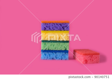 Sponges for washing dishes on a bright pink background 90140751