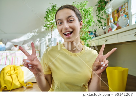 Teenage female student having video call, looking at webcam Teenage female student having video call, looking at webcam 90141207