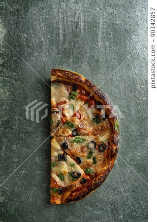 half a delicious homemade italian pizza on the table 90142857