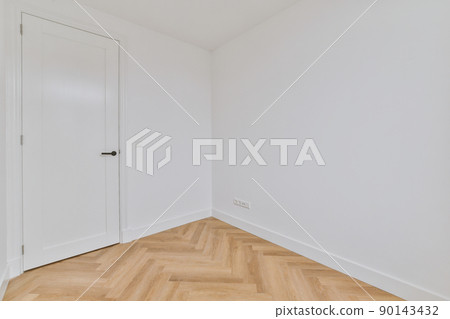 Corner of bright empty room with white walls and door in modern apartment Corner of bright empty room with white walls and door in modern apartment 90143432