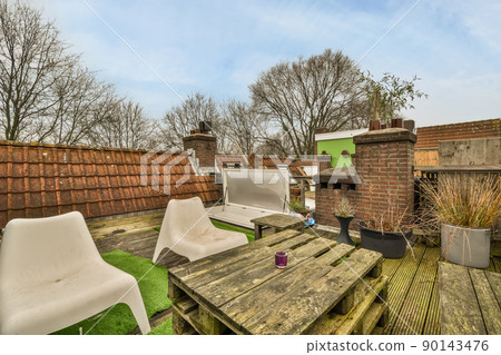 Interior of a small recreation area on the roof of a cozy house 90143476