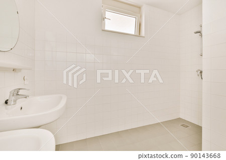 Interior of a bathroom with white tiles from a modern house, with two ceramic sinks and shower Interior of a bathroom with white tiles from a modern house, with two ceramic sinks and shower 90143668