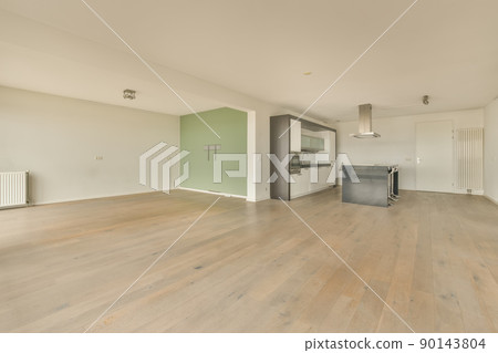 Corner kitchen in white with a bar in an open space studio apartment 90143804