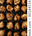 Freshly baked chocolate chip cookies on the net 90144534