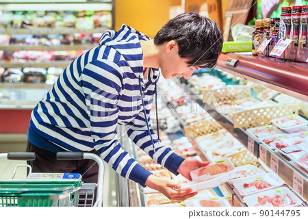 Young man buying meat at the supermarket Young man buying meat at the supermarket 90144795