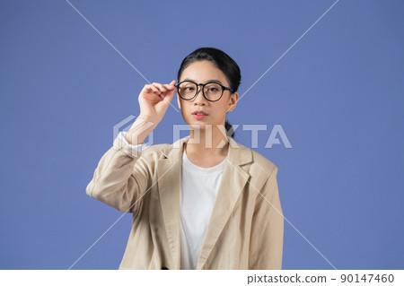 Asian young beautiful female arm holding hand adjusting fashion sunglasses on purple background. 90147460