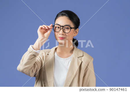 Photo of young girl happy positive smile fix glasses finger look empty space isolated over purple color background Photo of young girl happy positive smile fix glasses finger look empty space isolated over purple color background 90147461