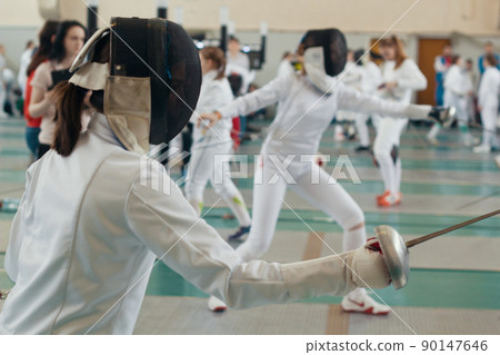 Fencing tournament. A girls holding a saber in the hall 90147646