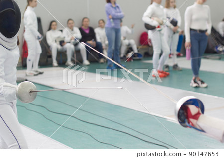 Two young person fencers practicing fencing duel 90147653