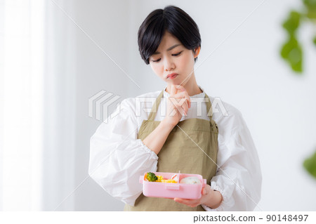 Mom making a lunch for a child 90148497