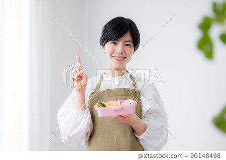 Mom making a lunch for a child 90148498