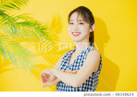 Summer woman yellow background 90148624