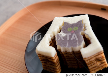 Die-cut Baumkuchen cat on a wooden tray and a black plate Die-cut Baumkuchen cat on a wooden tray and a black plate 90148823