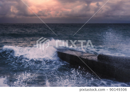 Storm at sea at sunset. Sea view with waves during rain and cloudy in Alupka. Crimea Storm at sea at sunset. Sea view with waves during rain and cloudy in Alupka. Crimea 90149306