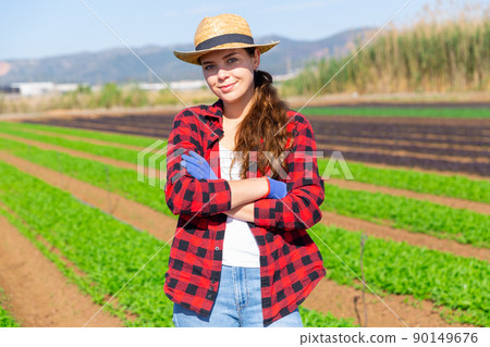 Woman farmer posing on leaf vegetables field 90149676