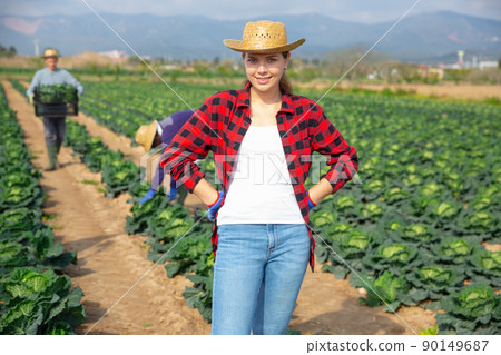 Portrait of successful female farmer on field 90149687