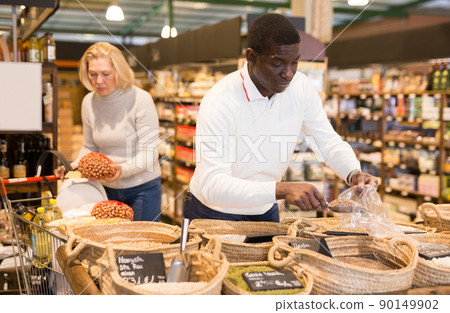 Man buying groats in supermarket Man buying groats in supermarket 90149902