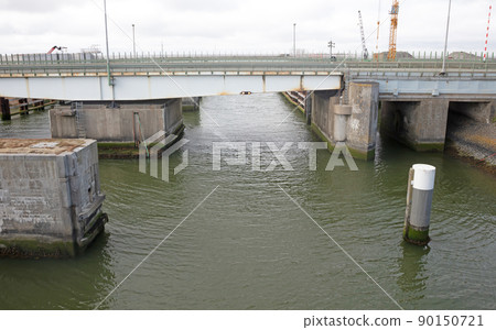 Old bridge with lights over dark water 90150721