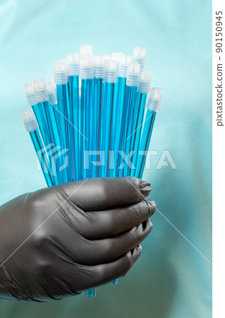 Dentist's hand in glove with saliva ejectors. 90150945