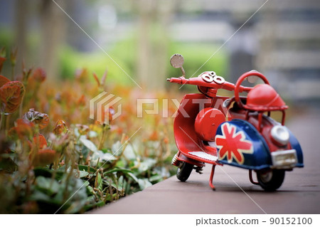 Red retro mini motorcycle miscellaneous goods and cityscape scenery plants green Red retro mini motorcycle miscellaneous goods and cityscape scenery plants green 90152100