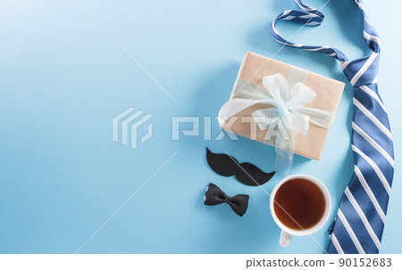 Happy Fathers Day background concept with gift box, decorated bow tie, necktie and mustache on bright pastel background. 90152683