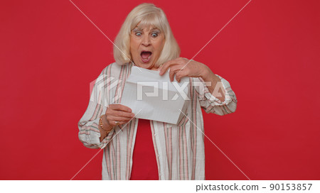 Senior woman open envelope letter read feel happy career growth advance promotion bank loan approve 90153857