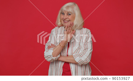 Senior woman smiling friendly at camera and waving hands gesturing hello or goodbye, welcoming 90153927